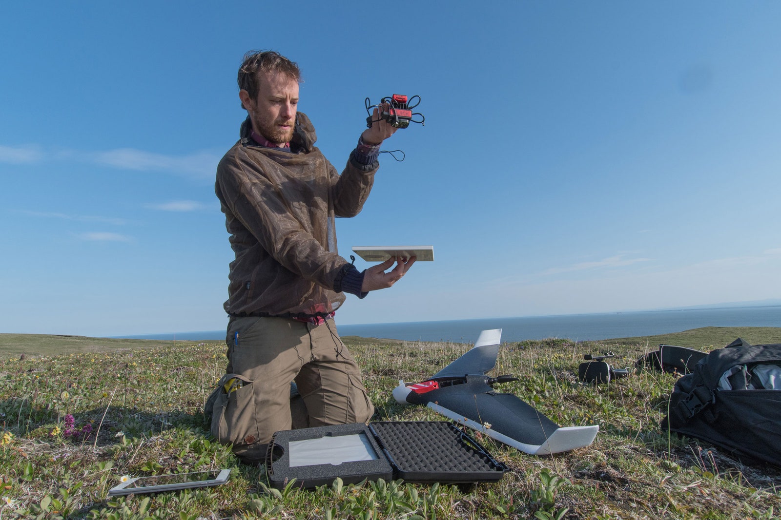 Jeff Kerby calibrating a drone sensor in a grass field